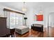 Cozy living room with hardwood floors, elegant lighting, and a comfortable ottoman at 2325 W Del Webb Blvd, Sun City Center, FL 33573