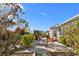 Charming patio area with dining set surrounded by mature landscaping at 2325 W Del Webb Blvd, Sun City Center, FL 33573