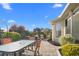 Charming patio area with outdoor dining set and well-manicured landscaping at 2325 W Del Webb Blvd, Sun City Center, FL 33573