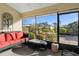 Enclosed sunroom featuring a comfortable couch, coffee table, and views of the backyard at 2325 W Del Webb Blvd, Sun City Center, FL 33573