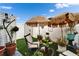 Private backyard featuring artificial turf, comfortable seating, tropical plants, and shaded umbrellas at 24862 Us Highway 19 N # 1701, Clearwater, FL 33763