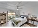 Bright bedroom featuring stylish decor, wood floors, and sliding glass doors to the outdoor area at 24862 Us Highway 19 N # 1701, Clearwater, FL 33763