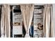 Spacious closet with built-in shelving and racks, with curtain doors, for optimal organization at 24862 Us Highway 19 N # 1701, Clearwater, FL 33763