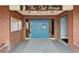 Inviting clubhouse entrance features brick facade, blue doors, and clear signage for easy access at 24862 Us Highway 19 N # 1701, Clearwater, FL 33763