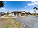 Charming home exterior with vibrant blue doors and well-maintained landscaping in a sunny neighborhood at 24862 Us Highway 19 N # 1701, Clearwater, FL 33763