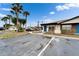 Exterior view showing ample parking and well-maintained landscaping with mature palm trees at 24862 Us Highway 19 N # 1701, Clearwater, FL 33763