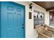 Inviting front entrance with a vibrant door, cozy seating, and stylish exterior lighting at 24862 Us Highway 19 N # 1701, Clearwater, FL 33763