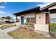 Charming front porch featuring cozy seating, a vibrant blue door, and manicured landscaping at 24862 Us Highway 19 N # 1701, Clearwater, FL 33763