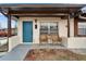 Inviting front porch with seating and a vibrant blue front door, perfect for relaxing outdoors at 24862 Us Highway 19 N # 1701, Clearwater, FL 33763