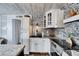 Well-appointed kitchen with stainless steel appliances, white cabinets, and stone backsplash at 24862 Us Highway 19 N # 1701, Clearwater, FL 33763