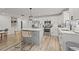 Bright kitchen with stainless steel appliances, white cabinets, an island with seating and a modern pendant light at 2523 W Abdella St, Tampa, FL 33607