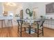 Dining area with wood floors, modern furnishings, and an open view into the kitchen at 2835 3Rd N Ave, St Petersburg, FL 33713