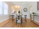 Bright dining area features wood floors, a modern chandelier, and views into the connected kitchen and sitting area at 2835 3Rd N Ave, St Petersburg, FL 33713