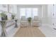 Bright entryway features neutral walls, a jute rug, sitting chairs and console table at 2835 3Rd N Ave, St Petersburg, FL 33713