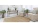 Bright entryway features neutral walls, a jute rug, sitting chairs and console table at 2835 3Rd N Ave, St Petersburg, FL 33713