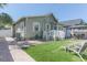 Home exterior with artificial turf, brick pavers, a small deck, and a gazebo with chairs at 2835 3Rd N Ave, St Petersburg, FL 33713