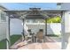 Gazebo in the backyard with a brick paver base and four wicker chairs around a table at 2835 3Rd N Ave, St Petersburg, FL 33713