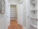 Hallway with wood floors, white shelving, and a view into a closet at 2835 3Rd N Ave, St Petersburg, FL 33713