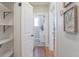 Bright hallway featuring hardwood floors, a closet, and open doorway to the adjacent bathroom at 2835 3Rd N Ave, St Petersburg, FL 33713