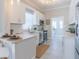 Modern kitchen with white cabinets, marble countertops, stainless steel appliances, and tile flooring at 2835 3Rd N Ave, St Petersburg, FL 33713