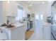 Modern kitchen boasts white cabinetry, quartz counters, stainless appliances, and eat in counter at 2835 3Rd N Ave, St Petersburg, FL 33713