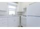 Compact kitchen with bright white cabinetry and standard appliances at 2835 3Rd N Ave, St Petersburg, FL 33713
