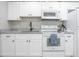 Well-lit kitchen showcasing white cabinetry, granite countertops, and stainless steel appliances at 2835 3Rd N Ave, St Petersburg, FL 33713