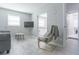 Cozy living room with wood-look tile flooring, a wall-mounted TV, and neutral paint scheme creating a modern feel at 2835 3Rd N Ave, St Petersburg, FL 33713