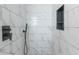 Modern shower with marble-look tiling, black fixtures, and a recessed shower caddy at 2835 3Rd N Ave, St Petersburg, FL 33713