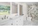 Renovated bathroom featuring a double vanity, elegant fixtures, and a marble-tiled shower at 2935 47Th S Ave, St Petersburg, FL 33712