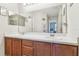 Bathroom featuring a double sink vanity with wood cabinets and a large mirror at 3002 Mojave Oak Dr, Valrico, FL 33594
