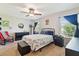 Well-lit bedroom featuring carpet flooring, ceiling fan, and ample natural light from two windows at 3002 Mojave Oak Dr, Valrico, FL 33594