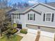 This is an exterior view of a two-story townhouse with a two-car garage and well-kept landscaping at 3002 Mojave Oak Dr, Valrico, FL 33594