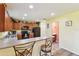 Bright kitchen with brown cabinets, breakfast bar and tile floors at 3002 Mojave Oak Dr, Valrico, FL 33594