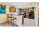 Eat-in kitchen with light cabinets, tiled floors, and breakfast bar at 3002 Mojave Oak Dr, Valrico, FL 33594