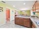 Spacious kitchen with tile flooring, lots of cabinet space, and opening to the half bathroom at 3002 Mojave Oak Dr, Valrico, FL 33594
