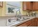 Close up of stainless steel kitchen sink with window, lots of counterspace, and stainless appliances at 3002 Mojave Oak Dr, Valrico, FL 33594