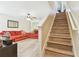 Open concept living room with wood flooring and view of stairs to the second floor at 3002 Mojave Oak Dr, Valrico, FL 33594