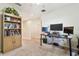 Open loft area with bookshelves, ceiling fan and multi monitor workstation at 3002 Mojave Oak Dr, Valrico, FL 33594