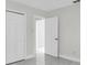 Bedroom featuring a closet and doorway to another room, complimented by tile flooring at 304 E Hanlon St, Tampa, FL 33604