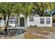 Charming single-story home featuring a well-maintained lawn, and a welcoming front door with the house number above at 304 E Hanlon St, Tampa, FL 33604