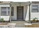 Charming front entrance with well-maintained landscaping, a gray front door, and classic architectural details at 304 E Hanlon St, Tampa, FL 33604