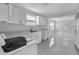 Modern kitchen featuring white cabinetry, sleek countertops, and stainless steel appliances, designed for style and functionality at 304 E Hanlon St, Tampa, FL 33604