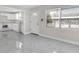 Open-concept living room with tile floors connecting to a modern, white kitchen at 304 E Hanlon St, Tampa, FL 33604