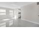 Bright, open living room with sleek tile flooring, sun-filled windows, and neutral color scheme at 304 E Hanlon St, Tampa, FL 33604