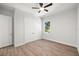 A serene bedroom featuring wood floors, a ceiling fan, and a large double door closet at 3410 W Pearl Ave, Tampa, FL 33611