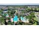 A wide aerial view of community amenities: swimming pools, clubhouse, and lush landscaping at 34244 Radley Way, Wesley Chapel, FL 33545