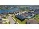 Stunning aerial view of a residential community with lake, pool, and manicured landscaping at 34244 Radley Way, Wesley Chapel, FL 33545