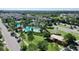 Beautiful aerial view of community pool, playground, and tennis courts amid lush green landscaping at 34244 Radley Way, Wesley Chapel, FL 33545