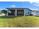 Well-maintained backyard with a screened-in patio for enjoying the outdoors and a partial fence at 34244 Radley Way, Wesley Chapel, FL 33545